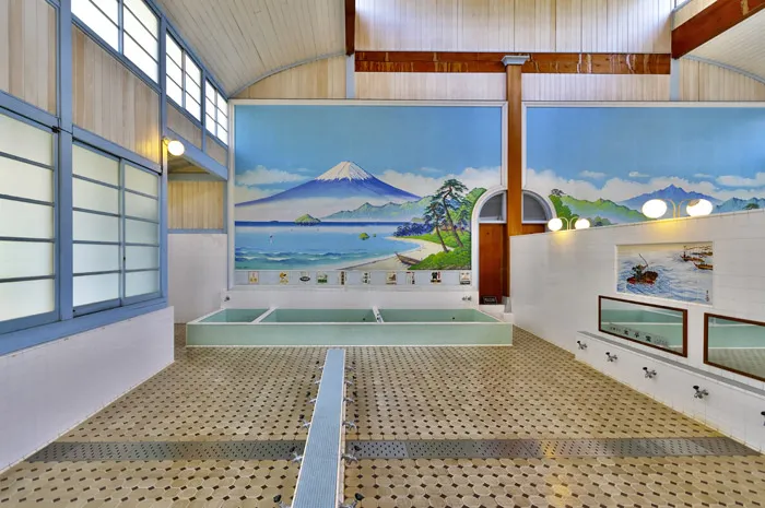 Interior of a traditional Japanese sento with Mt. Fuji mural, representing tattoo-friendly bathhouses in Tokyo