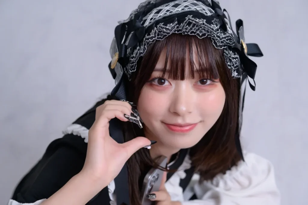 Maid costume staff member at a Japanese concafe, wearing a black and white outfit and headpiece