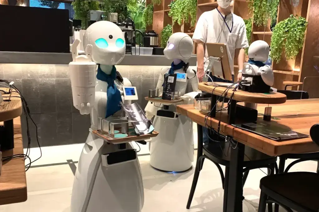 スクリーンショット 2026-01-04 17.44.05 OriHime avatar robots interacting with guests at DAWN Avatar Robot Cafe in Tokyo
