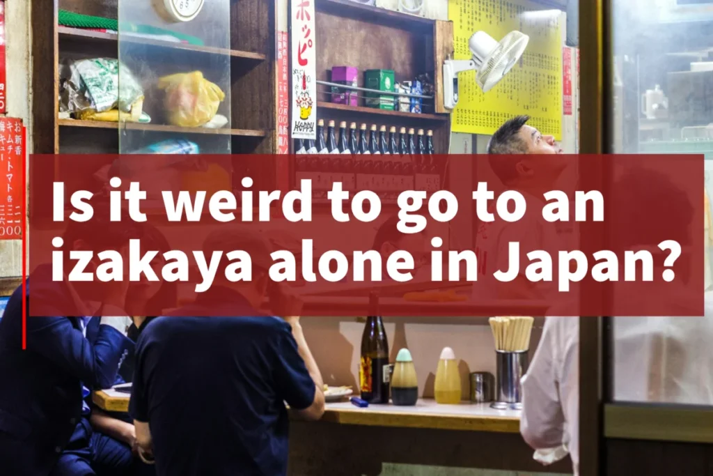 Inside a Japanese izakaya with counter seating and locals dining, questioning if going alone feels awkward