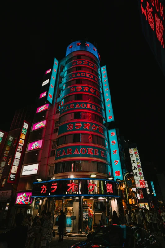 Karaoke Kan building in Shinjuku at night, popular family friendly karaoke experience in Tokyo