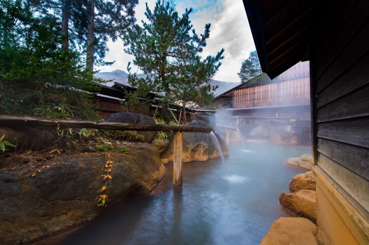 Outdoor Japanese onsen bath surrounded by nature