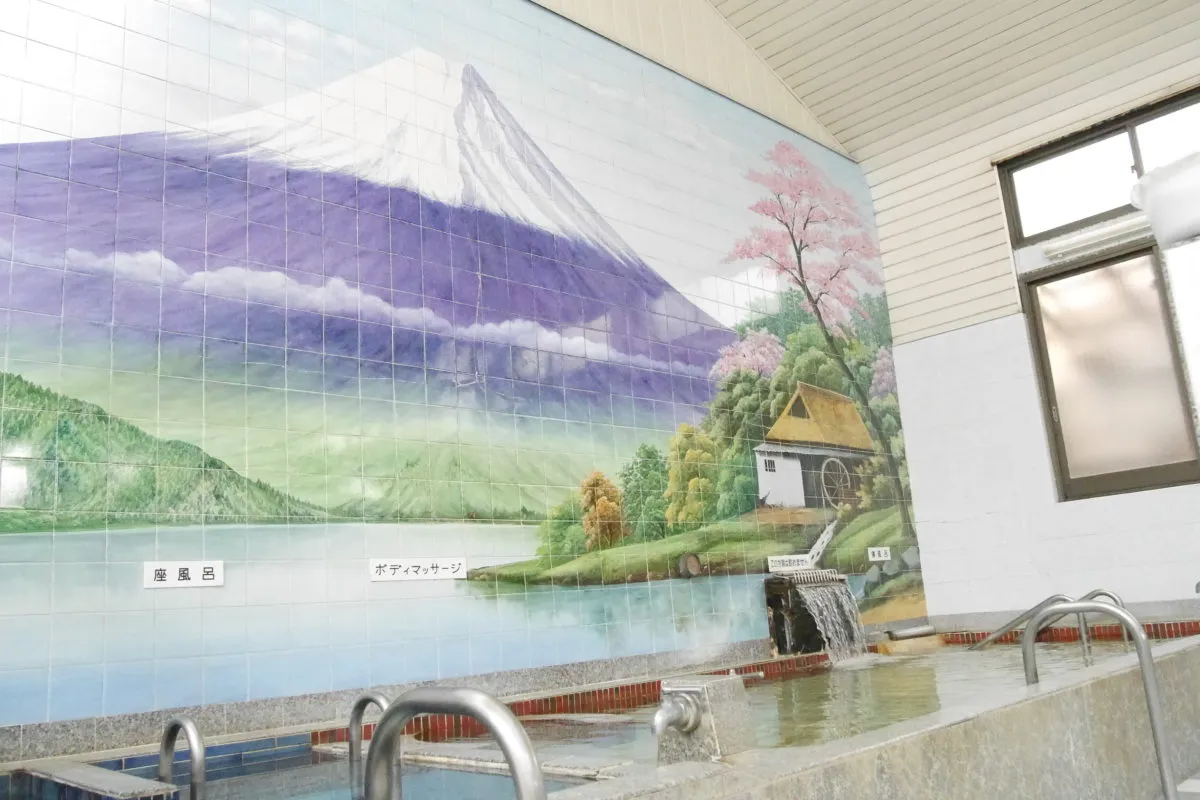 Japanese sento bath with Mount Fuji mural on tile wall
