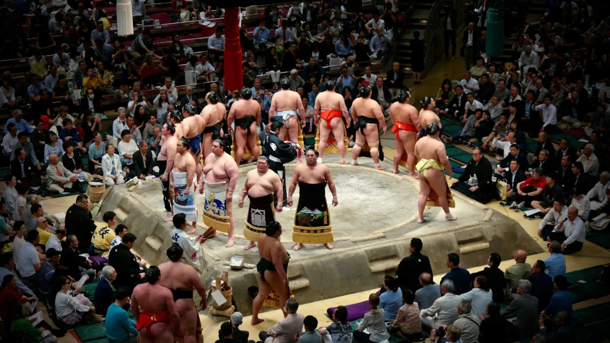 Sumo wrestlers competing inside a traditional sumo arena in Tokyo, Japan