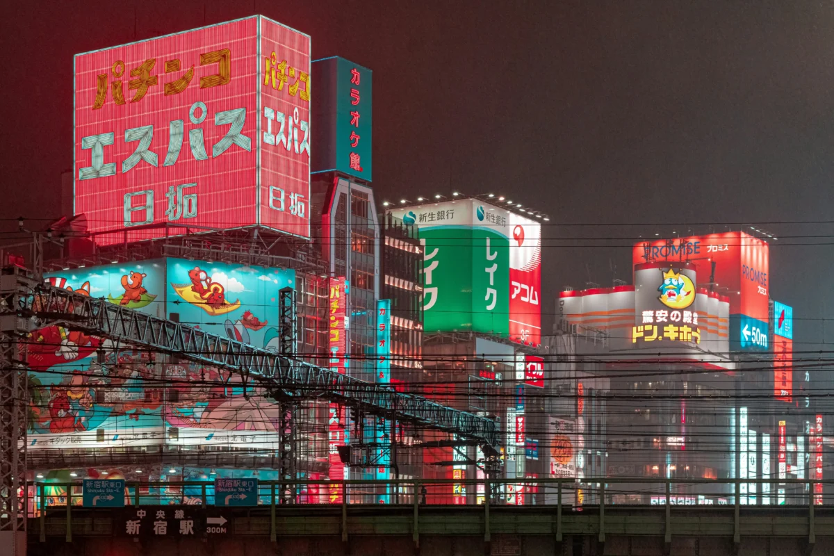 Shinjuku Tokyo at night with colorful neon signs and anime culture atmosphere