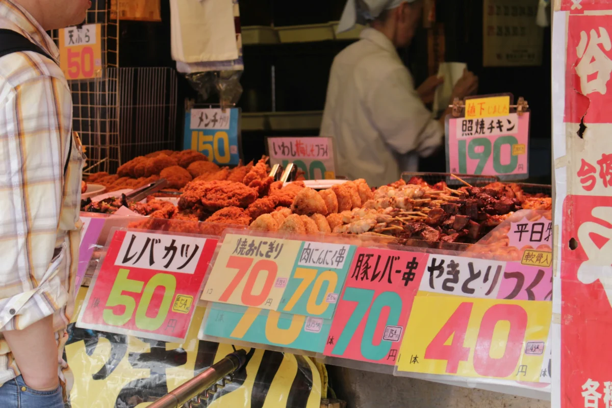 Local Japanese street food stall in Tokyo selling yakitori and fried snacks