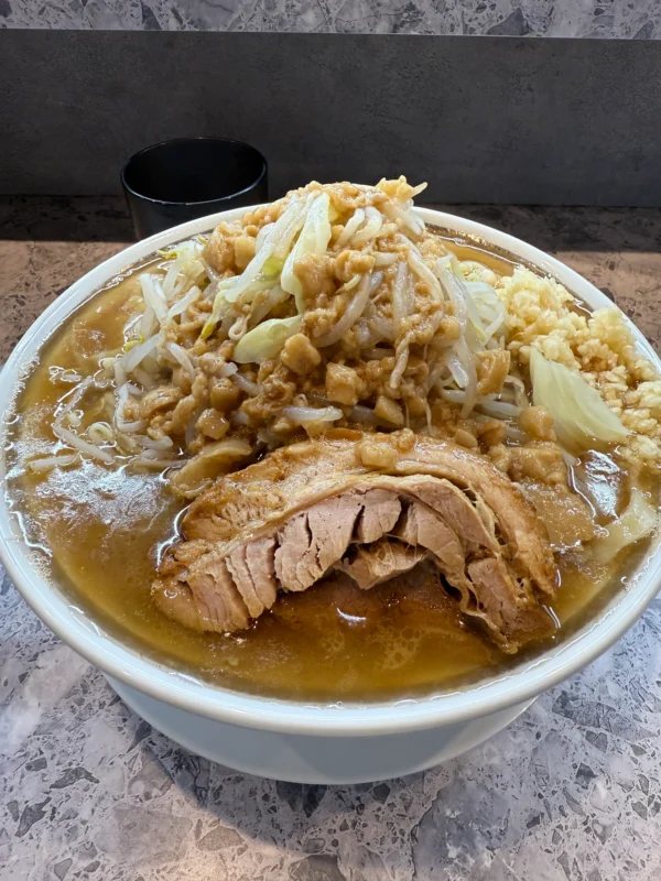 Jiro-style ramen topped with bean sprouts, cabbage, garlic, pork, and pork fat