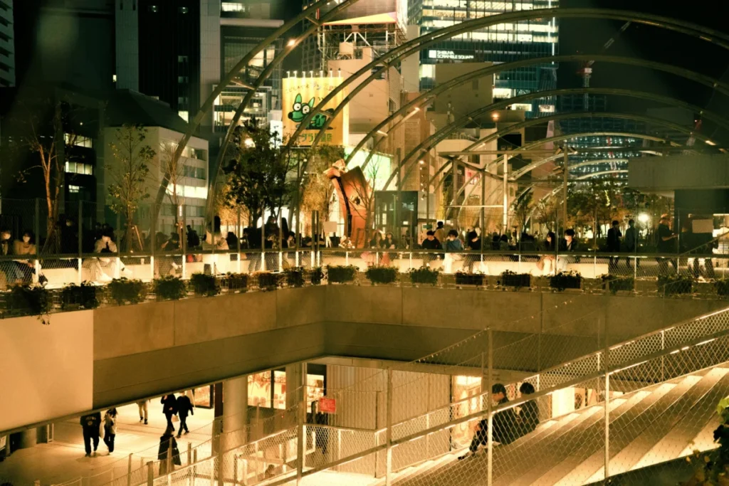 Miyashita Park rooftop in Shibuya at night with visitors relaxing outdoors