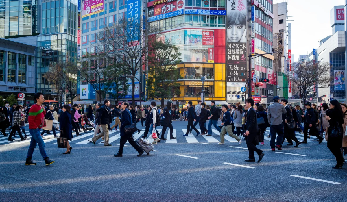 cory-schadt-Hhcn6yy3Uo8-unsplash Crowds walking through Shibuya Crossing in Tokyo, a popular area where travelers may hire a local guide in Japan