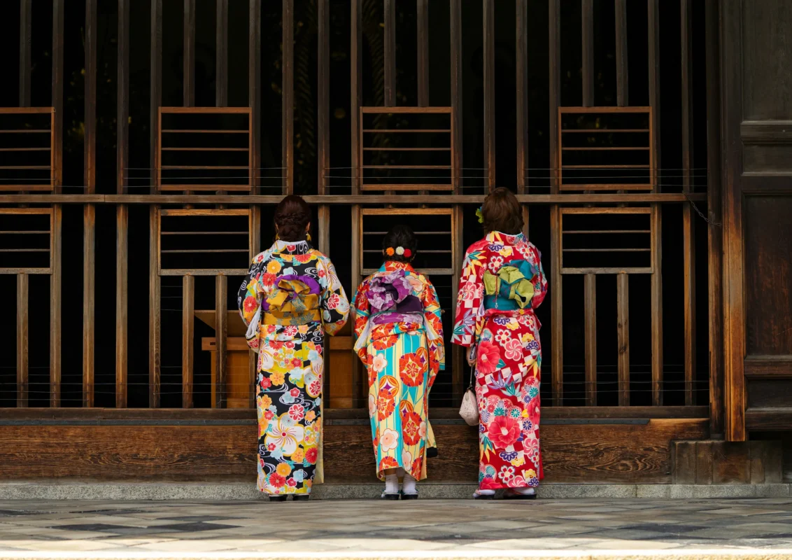 damian-hutter-KWhSooZLl2w-unsplash Three women wearing colorful kimono at a traditional wooden building in Japan