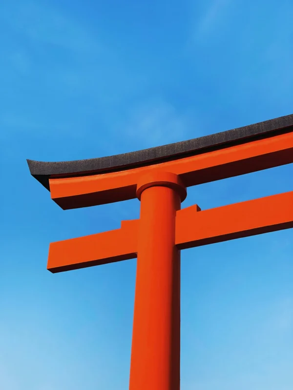 hoejin-iwai-2z64HSNTys4-unsplash Close-up of a red torii gate against a blue sky in Japan