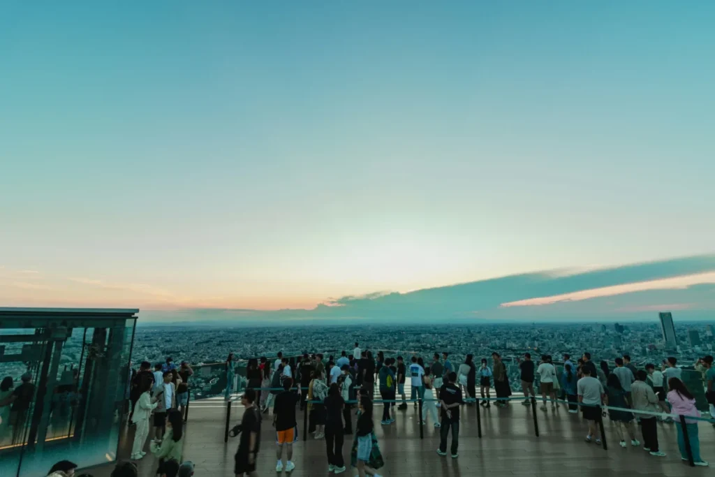 Sunset view from Shibuya Sky with visitors overlooking Tokyo