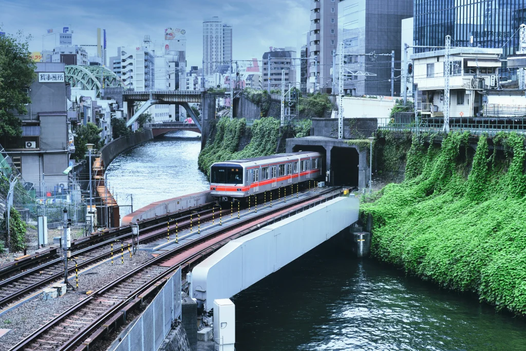 m-s-meeuwesen-CyQ9EzTUrM4-unsplash Tokyo subway train running beside a canal in the city