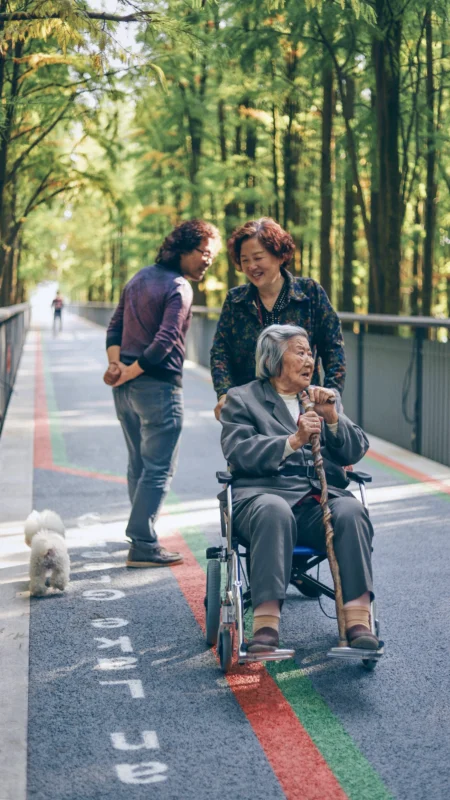 raychan-yk7F8bdD0eU-unsplash Elderly traveler using a wheelchair with family during an accessible trip