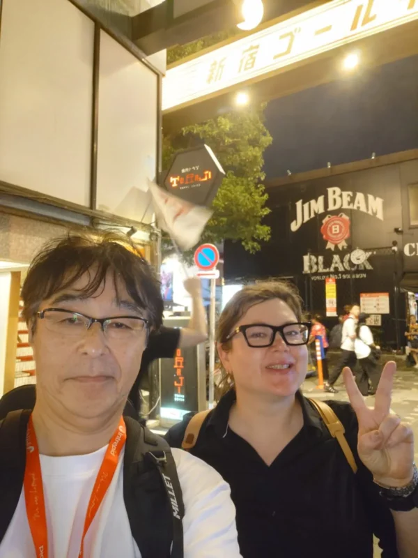 05915524-d05f-4383-b73f-5ccdd66bc515 2 Local tour guide with a traveler in Shinjuku nightlife district