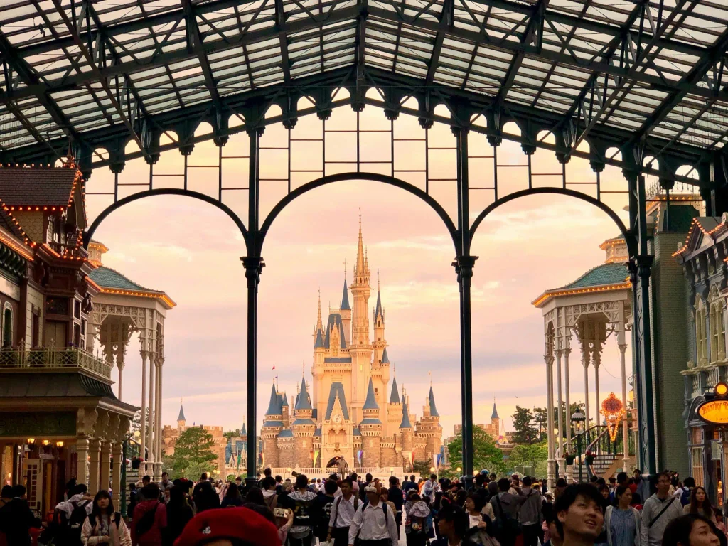 Tokyo Disneyland castle at sunset with visitors