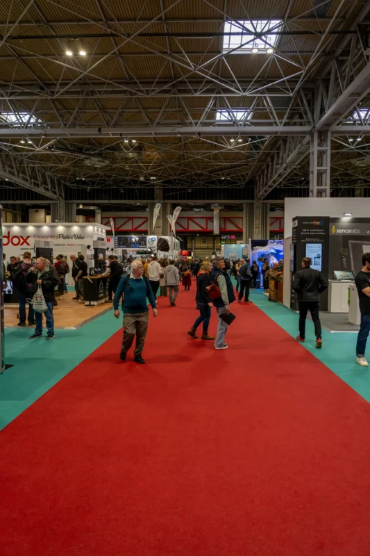 People walking through a busy international trade show