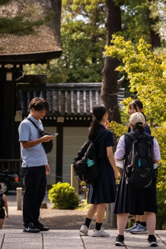 kristijan-arsov-pBaGn2I_Zws-unsplash Japanese students gathering near a traditional temple