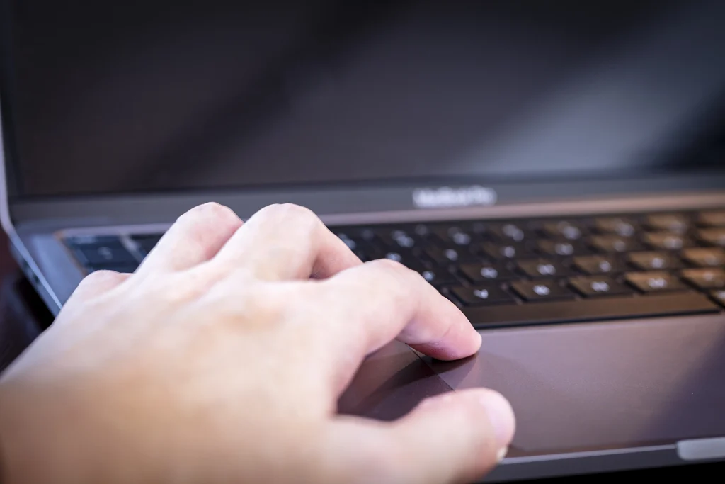 pc-operation_medium Close-up of a person using a laptop for travel planning and coordination