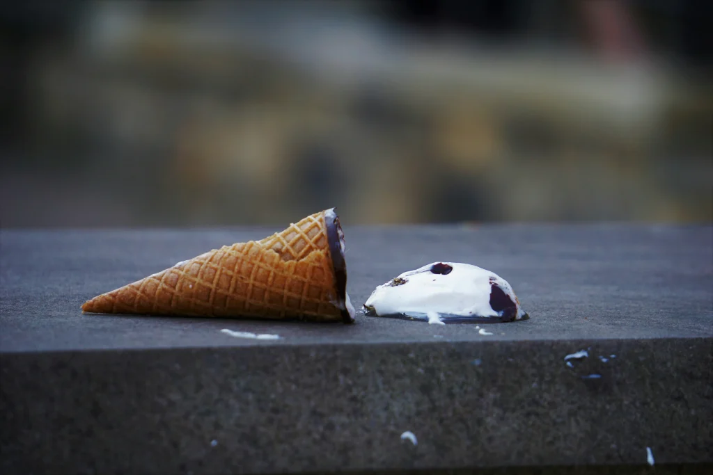Melted ice cream on the pavement during a hot summer day